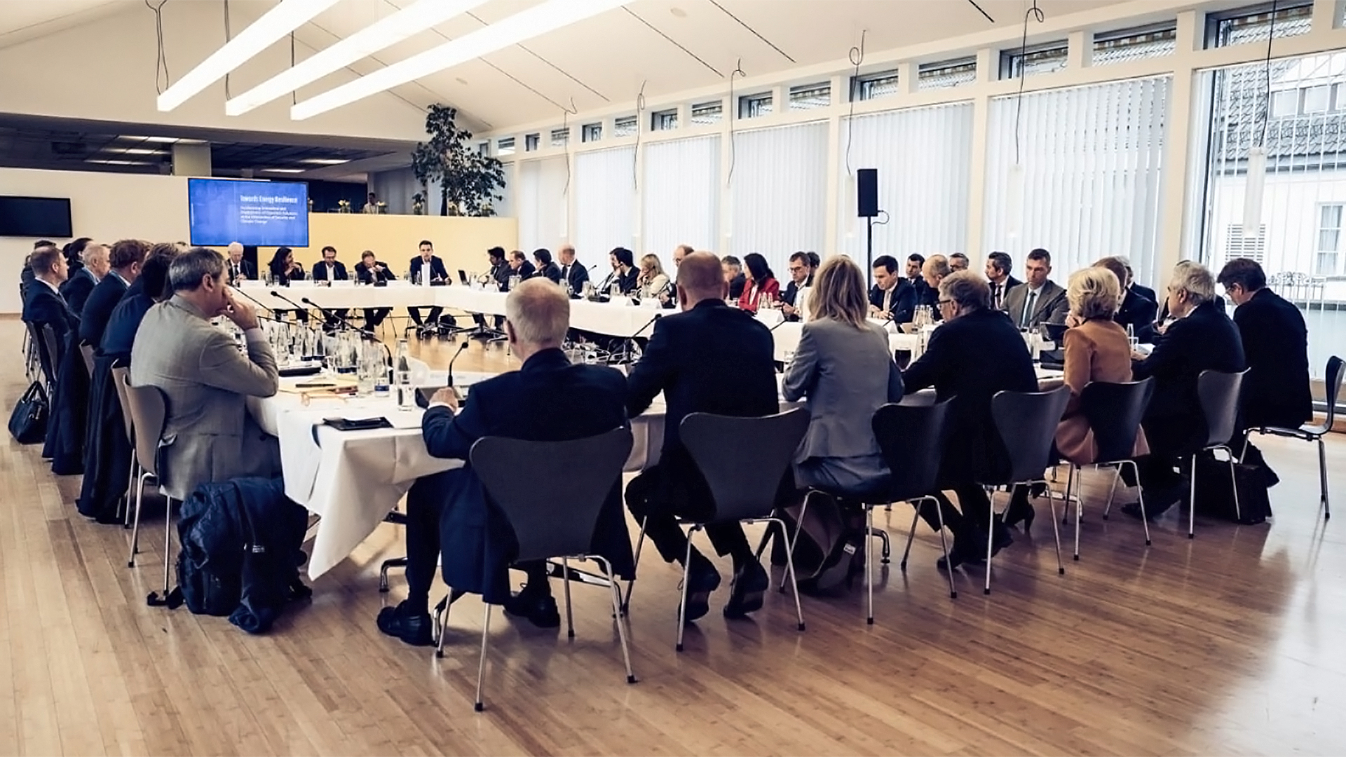 Launch event of the Energy Resilience Leadership Group at Munich Security Conference with senior policymakers, corporate and financial sector CEOs, and innovative climate tech startups sitting on a table.